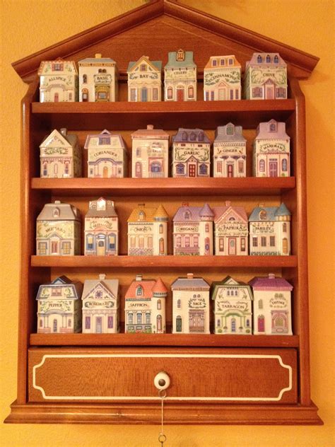 is the spice rack and porcelain jars from the Lenox Village Collection issued in 1989. The jars are in the Victorian home design as is the whole collection. The set consists of 24 spice jars with the