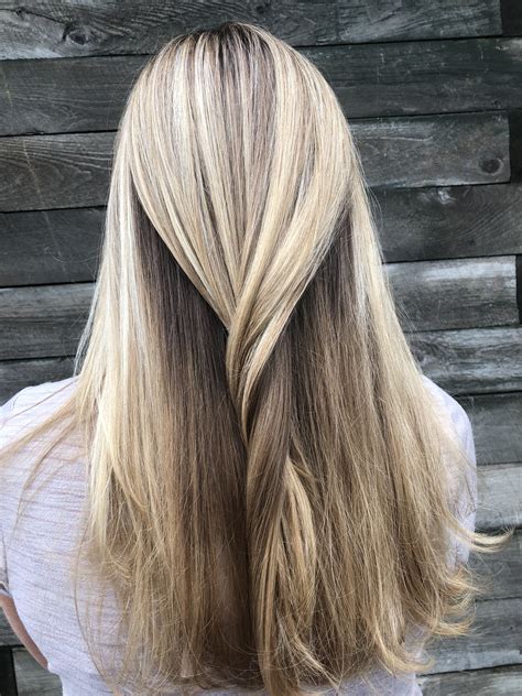 The best way to create depth and blended tones with a brown blonde balayage is to keep the dark close to your natural color. Take the lighter color feathered down the hair shaft. This will create beautiful ribbons of light and dark. After any blonding service, regular trims are advised to keep your locks healthy.