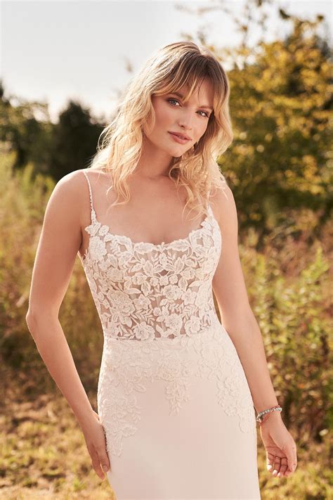 Lillian west bridal. Style 66176. Beaded and sequined laces are blended with dimensional laser cut chiffon flowers to create this whimsical wedding gown. Featuring an illusion bodice, a sweetheart neckline with delicate off-the-shoulder straps, and an open V-back. Soft layers of tulle and organza create the light A-line skirt with a chapel length train. 