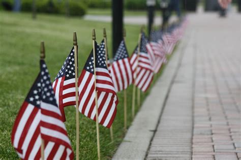 Local business marking Memorial Day with flag raising event