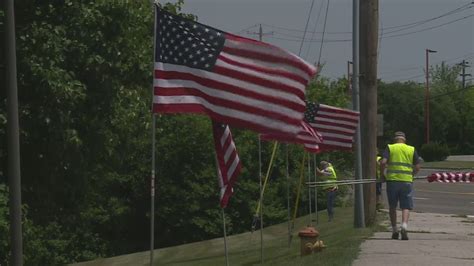 Local group displays hundreds of flags to honor fallen marine