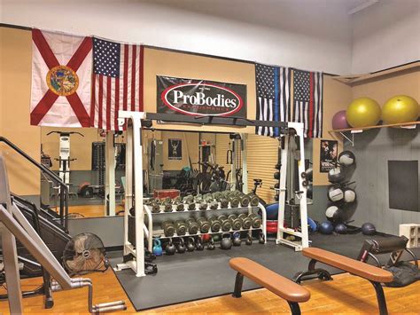 Local gym. You want to push the bar from your chest at the bottom up towards your face at the top. If you were lying the other direction the tracks of the smith machine would force the bar from your chest down towards your abdomen. No he’s sitting the right way. The bar is on a track and goes straight up and down. 