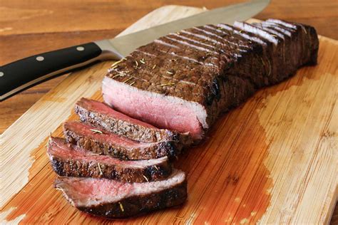 London broil steak. Step 3. Grill meat, marinade discarded, on an oiled rack set about 4 inches over glowing coals, turning each once, 9 to 10 minutes on each side, or until it registers 135°F. to 140°F., on a meat ... 
