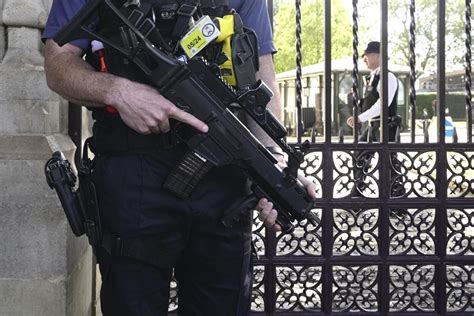 London police call for backup as armed officers lay down guns after colleague charged with murder