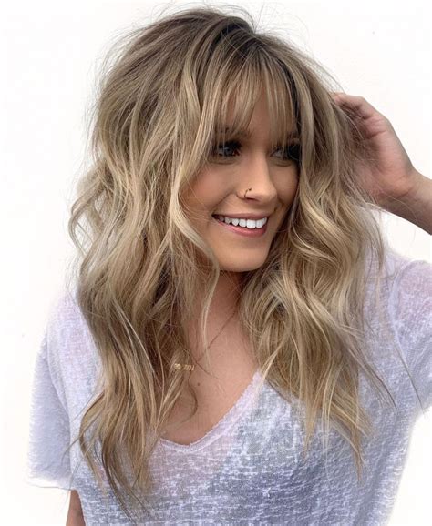 Some good haircuts for women with round faces include asymmetrical bobs and medium-length hair with side-swept bangs. Other cuts that tend to be flattering are long mixed-length la.... Long hair in layers with side bangs