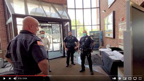 Contribute­d image / Screenshot from Long Island Audit YouTube channel A screenshot from video shows Danbury police officers who responded to a report of a YouTuber filmed a video inside the Danbury Public Library. Danbury Police Chief Patrick Ridenhour announced an internal investigat­ion into the incident.. 