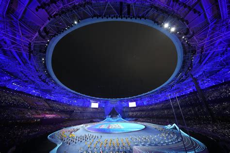 Lots of dignitaries but no real fireworks  –  only electronic flash  –  as the Asian Games open