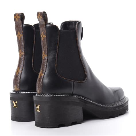 Discover Louis Vuitton LV Beaubourg Ankle Boot: The LV Beaubourg ankle boot in patent Monogram canvas is a fashionable chunky style mixing masculine and feminine codes. The upper, which was inspired by the classic Chelsea boot, is combined with a sturdy yet lightweight outsole. This model is signed with a gold-embossed leather patch and an LV Initials stud in the heel.. 