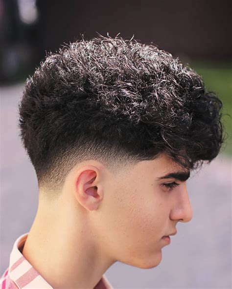 A low taper fade for curly hair is a haircut