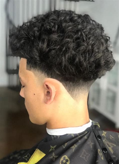 Low taper curly. 5. Low Taper Fade Curly Hair. The low fade with curly hair has become on of the most popular haircuts for men.The cut gradually shortens the hair on the sides of the head while keeping the top longer, creating a subtle contrast that gives the hair structure. 