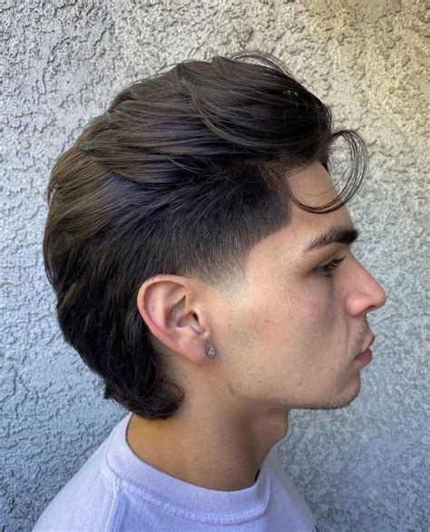 Taper Burst Fade Mullet: Dynamic Contrast in Hair Lengths. Th