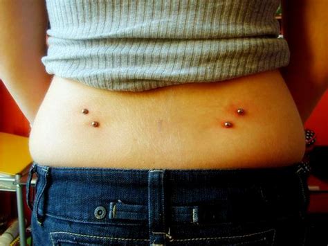 Lower back piercing. A back dimple piercing is a type of surface piercing that is done on the lower back, just above the waistline. This piercing has become increasingly popular in recent years, especially among women. While a back dimple piercing can be a very attractive body modification, there are some things you should consider before getting one. 