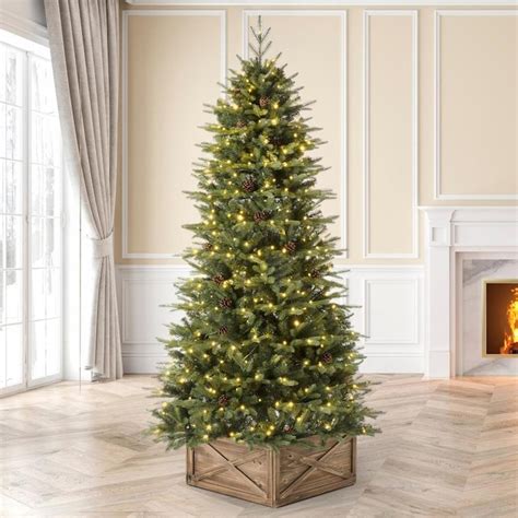 Holiday Living Everett Grand 7.5-ft Fraser Fir Pre-lit Artificial Christmas Tree with LED Lights. Add a touch of sophistication to your holiday decorating. At 7.5-ft tall and a 62-in diameter this tree is very full and adorn with 1200 warm white/multicolor LED lights with 9 functions. emitting elegance and boasting 3189 branch tips, this gorgeous full shaped tree features an exceptional .... Lowes artificial trees with lights
