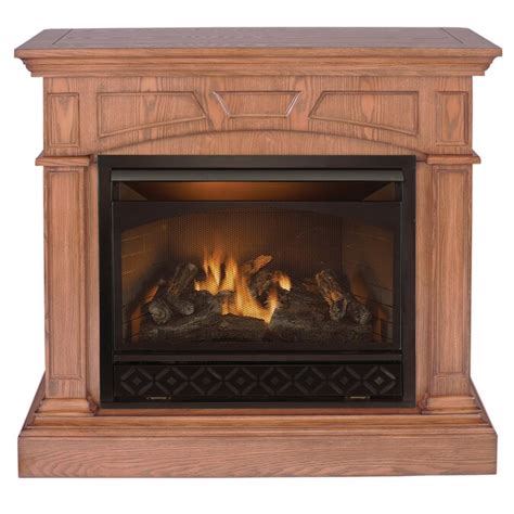 Oak finish wood and metal dual-burner gas fireplace heats up to 700-sq ft areas. 38.25-in H x 35.75-in W x 29.5-in D. Uses natural gas or liquid propane fuel to deliver 20,000-BTUs. Thermostat makes it easy to select heat levels and maintain a comfortable temperature. Electronic spark ignition allows for fast startups.