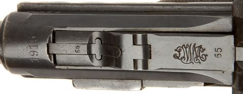 Luger markings. The barrel length is 4" (100mm) and is chambered for 9mm. The serial number appears on the front of the frame, on the left side of the receiver, on the side plate sear and trigger. The thumb safety is marked "Gesichert" and when exposed (safety down) means safe. The Luger has all matching numbers including the magazine. 