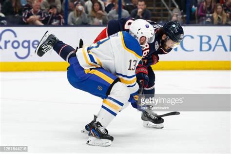 Lukas Rousek of the Buffalo Sabres and Kirill Marchenko of the...