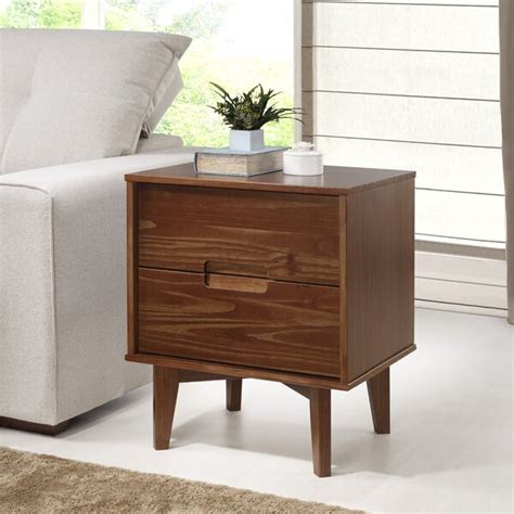 Mags solid wood nightstand. This 2-drawer nightstand features inset paneling and clean lines for a traditional and functional piece in your bedroom. The frame is made from solid and engineered wood with a crisp neutral finish, and it rests on straight legs. Two soft-close drawers open on roller glides revealing room for reading glasses, chargers, and books. We love how the gold … 
