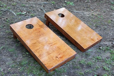 Make cornhole boards. Cut down enough 1×4 to make a frame for each piece of plywood. Drill pocket holes in the frame to connect the pieces. Connect the frame pieces with pocket hole screws. Glue on the plywood, then nail it in place with brads. Draw a 6″ diameter circle 9″ from the top of the board, and horizontally centered. 
