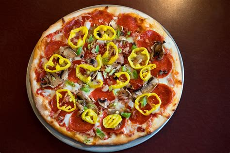 Make your own pizza restaurant. The Create Your Own Pizza allows up to three toppings included in the price with $1.50 for each added topping. Topping options are abundant and include vegetables, proteins, cheeses, and sauces. 