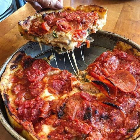  So naturally I had to try Lou Malnati's. We ordered a deep dish Chicago Classic which came with Italian sausage and we added pepperoni. The pizza was huge! We ordered a large because we were sharing amongst four people but at least 6 ppl can eat off this. The pizza was just ok to me but I will say the marinara was really fresh! 