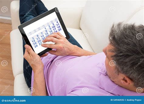 Man Looking at Calendar in Digital Tablet Stock Image Image of