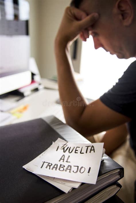 Man at Office and Text Back To Work in Spanish Stock Photo Image of