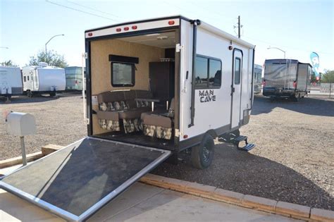 Cable Assisted Ramp Door. 2 Wheel Electric Brakes. Lockable Service Doors. Powder Coated Wheels. Tie Down Anchors. Deep Cycle Battery. R-7 Insulated Walls & Ceiling. Emergency Escape Window. Carson's FR Front Kitchen Rebel Toy Hauler Trailer - 7' x 14' Enclosure, 18' Over-all Length, 3,200# Trailer Weight, 78" x 72" Ramp Door - lots of great ...