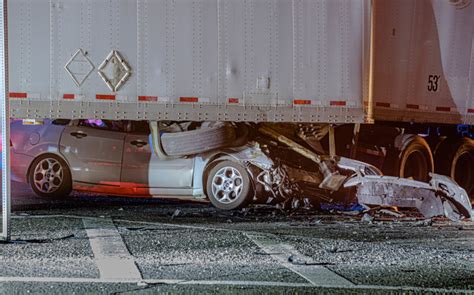 Man dies after car ends up wedged under semi-trailer, Aurora PD says