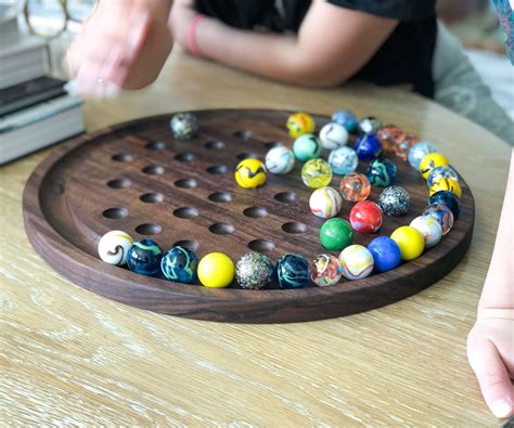 Marble Solitaire Board Game, Solitaire Game, Solitaire game with 36 Stainless Steel balls, Marble Solitaire, Coffee Table Decor (34) NZ$ 220.26. FREE delivery Etsy’s Pick Add to Favourites Oakwood Made Marble Solitaire Boards 9 inch - Glass Marbles Included |Valnetine Gift Ideas for Him (164) .... 