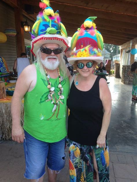 Margaritaville themed outfits. Consider wearing a shirt that has a tropical theme, such as vibrant island flowers. Shirts commonly worn by Jimmy Buffett fans are Hawaiian shirts. Alternatively, you could wear an article of clothing that references Jimmy Buffett directly, such as a T-shirt that you purchased at a Jimmy Buffett concert. It is also acceptable to wear a bikini top. 