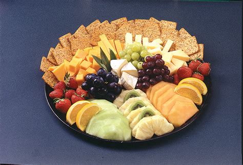 Market basket cheese platter. Add some fresh fruit and fill in any empty spots with nuts, plus more fruit. The key is grouping everything in piles and mixing different shapes, sizes, and colors. Get creative with it. Keep in mind – cheese tastes best at room temperature. Let the cheese sit at room temperature for about 30 minutes before serving. 