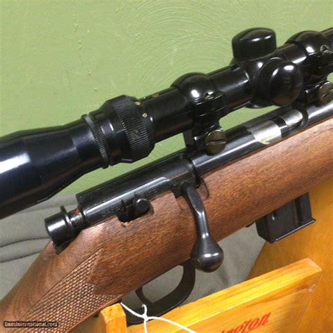  Description: Marlin Model 882 - Bolt Action . 22 Magnum Rifle - Checkered walnut pistol grip style stock and forend with swivel studs. Cushioned butt pad in excellent condition. 22 in . long barrel with open folding rear sight and a hooded front bead sight. 7 round clip style magazine. Receiver grooved for scope. . 