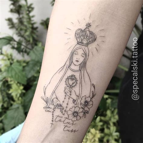  This Virgin Mary tattoo captivates with its dramatic use of shading and light, giving depth to the iconic image. The artist skillfully incorporates traditional symbolism, such as the radiant halo and her prayerful posture, creating a powerful representation of faith and devotion that stands out on the skin. . 