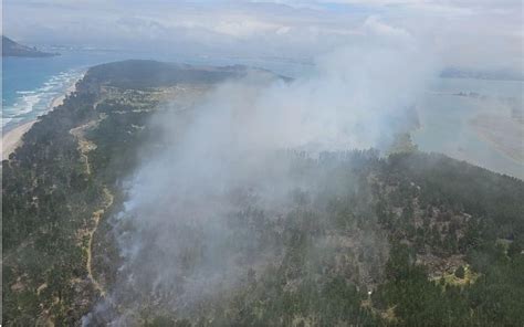 Matakana newspaper.  Crews worked overnight to create firebreaks to hold back...
