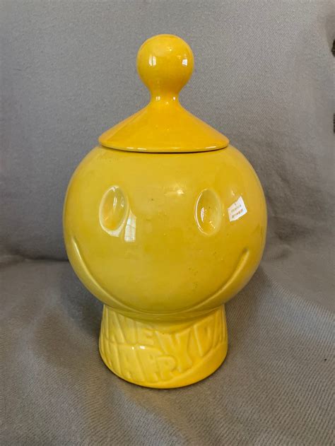 Mark: McCoy USA (round) Date Produced: Produced in 1971: Description: McCoy Happy Face Cookie Jar with "Have A Happy Day" on pedestal: Collector Value : $60.00 - $80.00. 