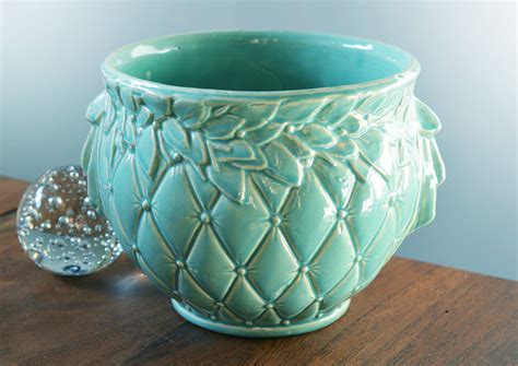Nelson McCoy Jardiniere in Matte Green Basketweave, leaves and berries pattern with tab handles Measures 7 1/4" tall by 8 1/2" top diameter opening Late 1930's - 1940's Nelson McCoy mark on the bottom "NM USA" McCoy Art Pottery. See all.. 