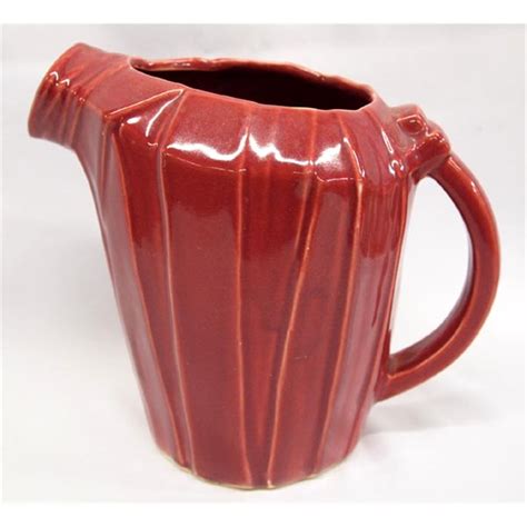 This Vintage McCoy Pitcher was made in 1941 and is pictured on page 167 of the red covered Sanford Guide to McCoy Pottery. It is in fantastic condition. No chips, cracks. This beautiful, classic, vintage McCoy pitcher measures 61/4 " tall and 8" from the handle to the tip of its beak at the spout. Unmarked but definitely McCoy guaranteed!. 