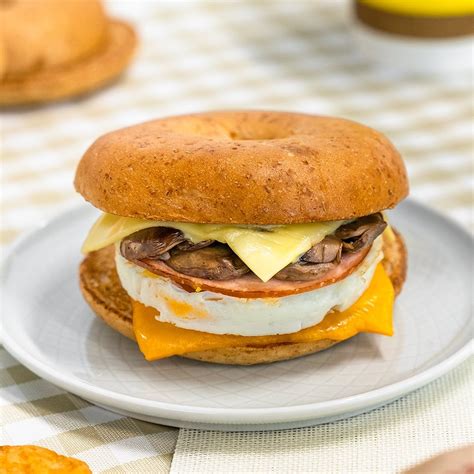 Mcdonalds breakfast bagel. Fuel up New York style with your choice of a NYC Benedict Bagel or a BLT Bagel, partnered with a Sausage McMuffin ®, a hash brown, and a Hot Chocolate. Available between 5.00am and 11.00am at participating restaurants. Hunger Buster Meals include a small hot chocolate. 