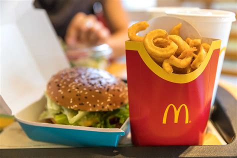 Mcdondal. McDonald's. Per burger: 300 calories, 13g fat (6 g saturated fat), 720 mg sodium, 32 g carbs (2 g fiber, 7 g sugar), 15 g protein. A single slice of cheese adds 50 calories to the burger and a few more grams of protein. While it also contributes some saturated fat, the total count is still reasonable for a meal. 