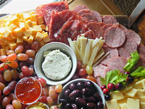 Meat and cheese platter. Ingredients. summer sausage yellow cheese, cut into square slices white cheese, cut into slices black olives. Directions. Arrange summer sausage slices for Santa's hat and rosy cheeks and nose, yellow cheese slices for his face, white cheese slices for his beard, moustache , eyebrows and for the end of his hat on a large, round party platter. 
