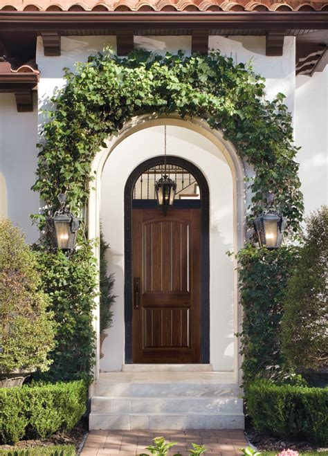 Mediterranean front doors. Reminiscent of sun-soaked European architecture, the Mediterranean Knotty Alder Square Top V-Groove Prehung Exterior Double Door from Krosswood Doors features luxurious wood grain, textured knotting, decorative iron details, and two unique speak-easy windows with a functioning latch. Our doors are crafted with superior doweled construction and hand-finished in the United States to ensure that ... 