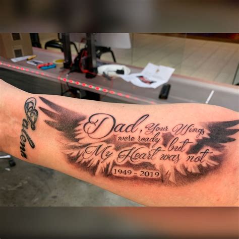 Memorial tattoo dad. These show what is possible with just black and gray ink. Through the use of fully saturated black ink, smooth gray wash shading, and negative space to create contrast, a tattoo artist can capture emotional moments that highlight the deep father son connection. 2. Father Son Silhouette Tattoos. 