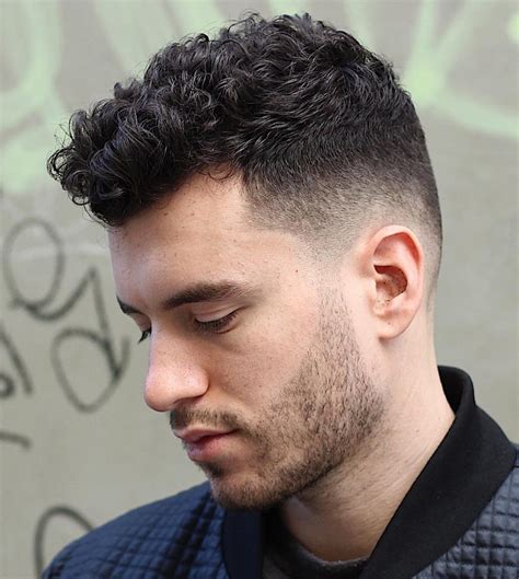Mens curly hair styles. Photo: Shutterstock. A fade is one of the most popular options for men with curly hair and can produce an incredibly stylish and unique look. The fade technique starts with a tighter haircut at the nape of the neck, gradually blending into longer curly locks at the top. This showcases the hair’s natural texture while achieving a polished look. 