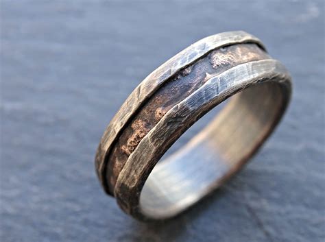 Mens custom wedding rings. Darkened Tantalum Classic Style Men's Ring $429.60 $537.00. Tantalum and 14K Gold Men's Ring Custom Made $944.80 $1,181.00. 14K Rose Gold and Tantalum Mens Ring $1,245.60 $1,557.00. Tantalum Band with Sand Finish Custom Made Men's Ring $429.60 $537.00. Tantalum and Black Titanium Vintage Floral Mens Band $585.60 $732.00. 