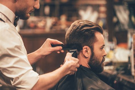 Mens hair cutting near me. Low Fade with Thick Wavy Hair. This popular style for thick, wavy hair is by far one of the best haircuts. It starts with a simple cut that keeps hair longer on top and in the front, then fades toward the nape and the ears. A pomade with shine finishes the look; just add a small amount to damp hair and comb it back. 