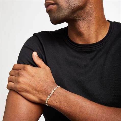 Mens tennis bracelet. Menswear bracelets have become a popular accessory in recent years, adding a stylish touch to any outfit. However, many men are unsure of how to wear these bracelets and which occa... 