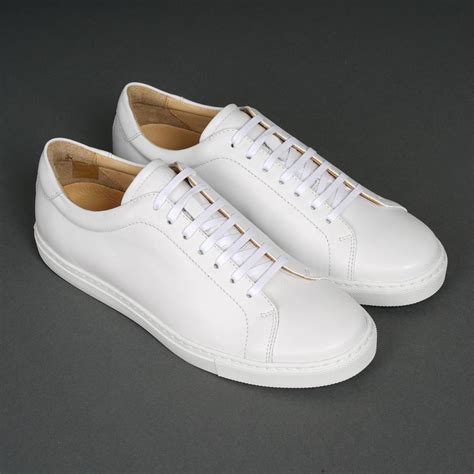 Mens white leather sneakers. New Republic Kurt Leather Sneaker – $98. Cole Haan Grand Crosscourt II Sneaker – $90 (on sale $49.99) Cariuma IBI Off-White Knit – $98. Adidas Stan Smith Leather Sneakers – $76 ( read the review here) Adidas Originals Continental Vulc – $60. Adidas Supercourt Shoes – $40. Nike Air Force 1 Low – $90. 