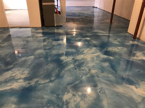Metallic epoxy floors. A metallic epoxy floor coating can look like the following: Marble slab flooring. Lightening strike. Lava lights. Moon craters. Liquid metal. Thunderstorm clouds. Tinted glass. Metallic Epoxy is a style of epoxy application that involves mixing between two and 5 colors together using swirling techniques to provide a completely unique floor. 