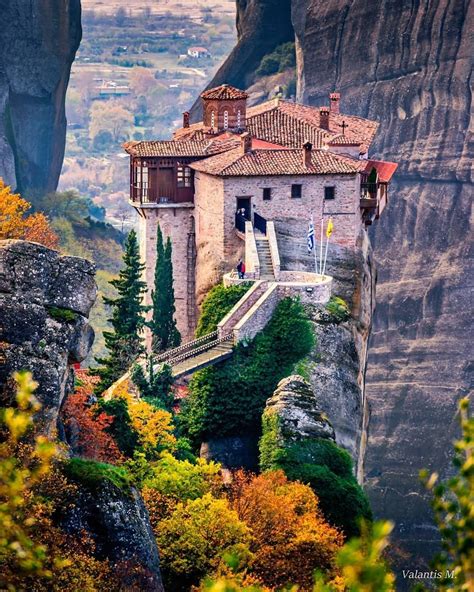 Meteora greece monastery. The rising sun illuminates the Monastery of the Holy Trinity and parts of nearby village of Kalabaka below, at the Meteora rock formation in central Greece. The monastery was built between the ... 