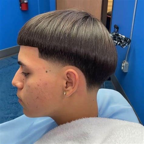 Mexican bowl cut guy. Refined Chili. Smooth is the name of the game with this haircut. The Chili bowl neatly wraps around the head with a simple brush from the middle of the head downwards. Instead of shaving the sides or using a fade, the hair hangs a little lower for sideburns. CREDIT: @gimmedatbowlcut. 